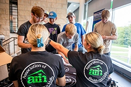 UND students draw for prizes at the ARH table at a theme meal in Wilkerson Dining Center