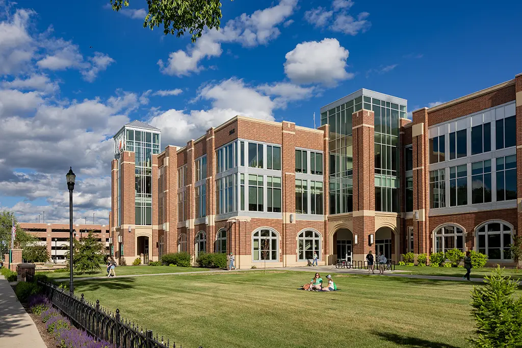 Exterior of UND Union and with people sitting outside on the grass