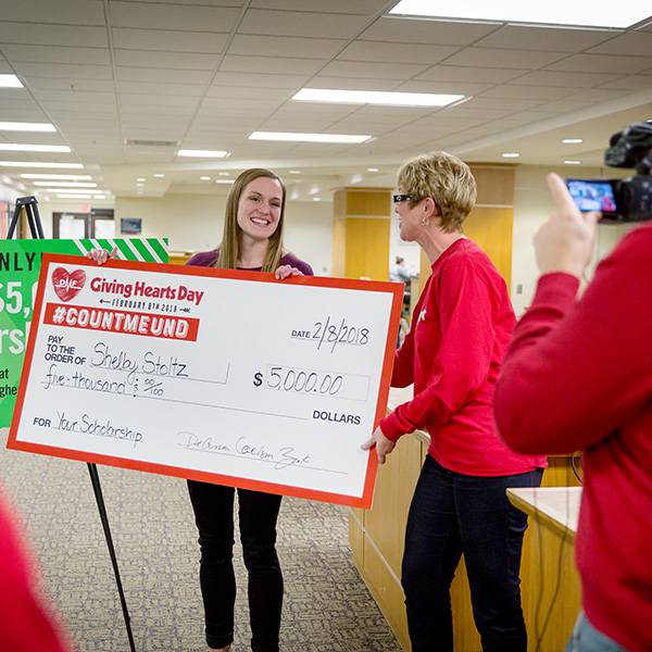 Student getting big scholarship check