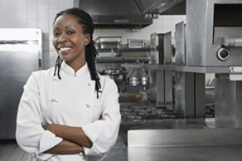 Female chef smiling in the kitchen