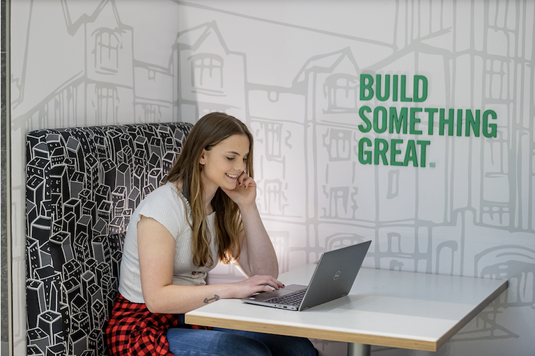 Photograph of a UND student studying on her laptop.