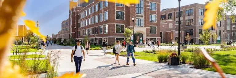 Students walk through UND quad on a fall day