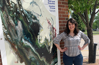 Heather Krause standing in front of her Art in Grand Forks, ND