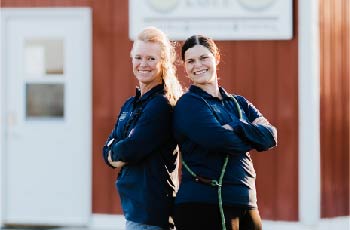 Lila Teunissen and Michelle Thomsen standing in front of their store, Bed 'N Biscuit Ranch in Bismark, ND