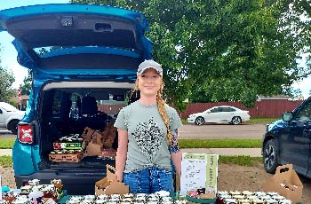 Cassandra Mosbrucker staning with her Ginger Leaf Garden in Mandan, ND