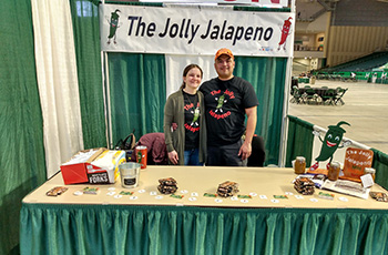 Alfredo Lugo standing at his stand called, The Jolly Jalapeno in Grand Forks, ND