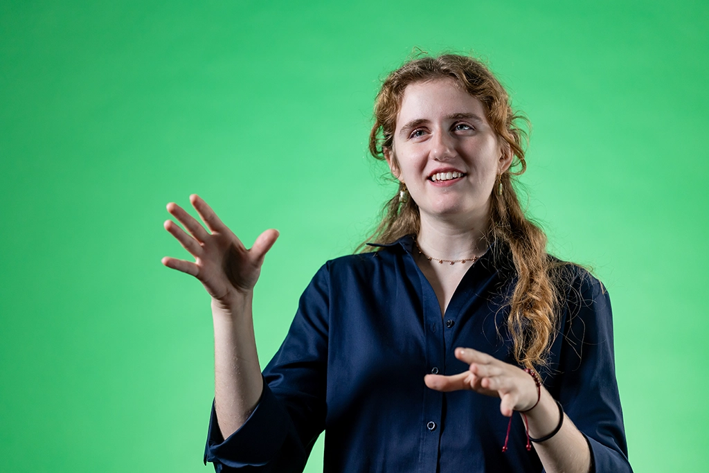 elisabeth hands in air explaining her chemistry degree