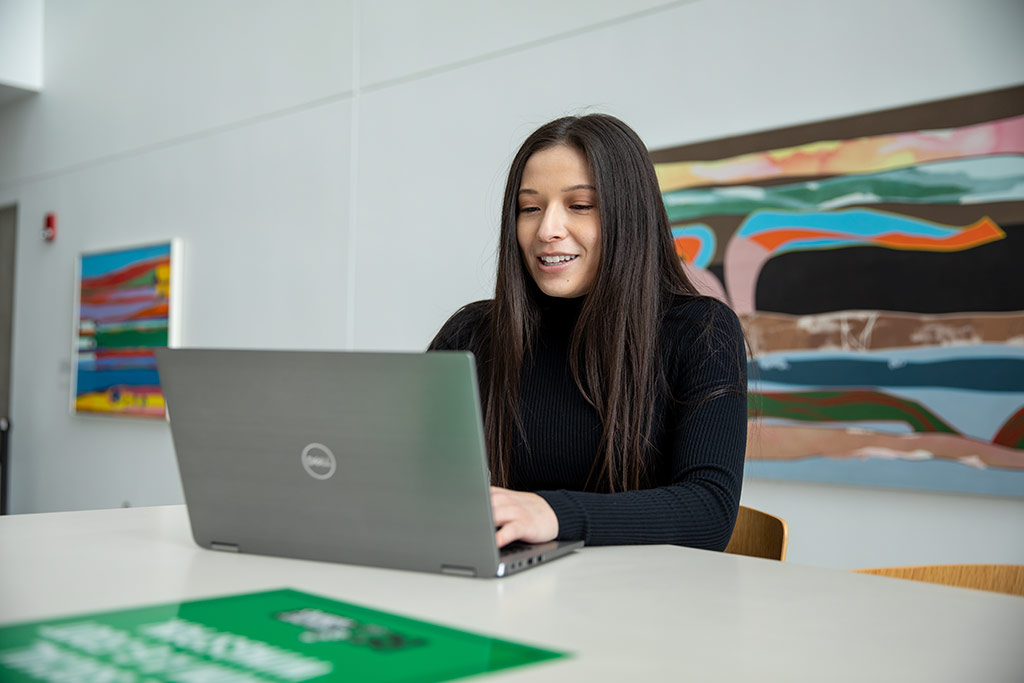 Kayana Trottier on a laptop