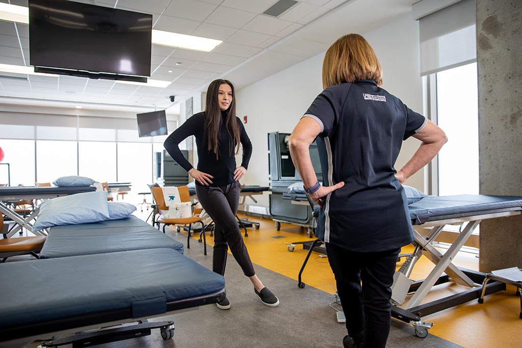 Kayana Trottier working with professor on physical therapy