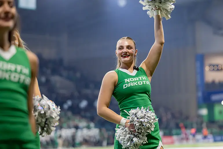 renee at und football game as cheerleader