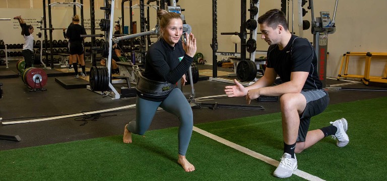 kinesiology student doing lunges