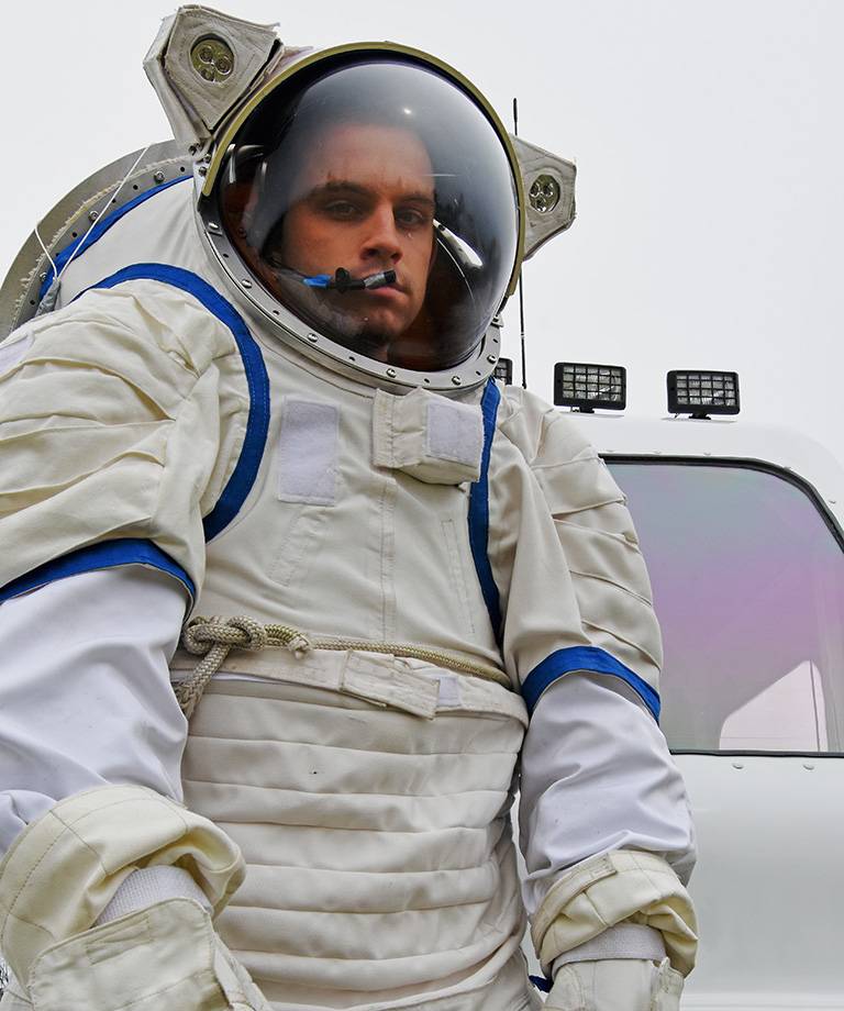 space studies masters student in space suite