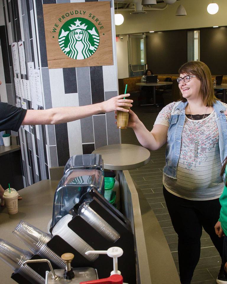 two students receiving coffee drinks