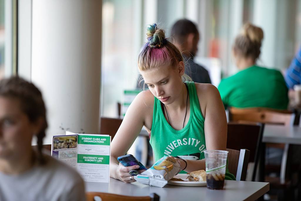 student eating at dining center