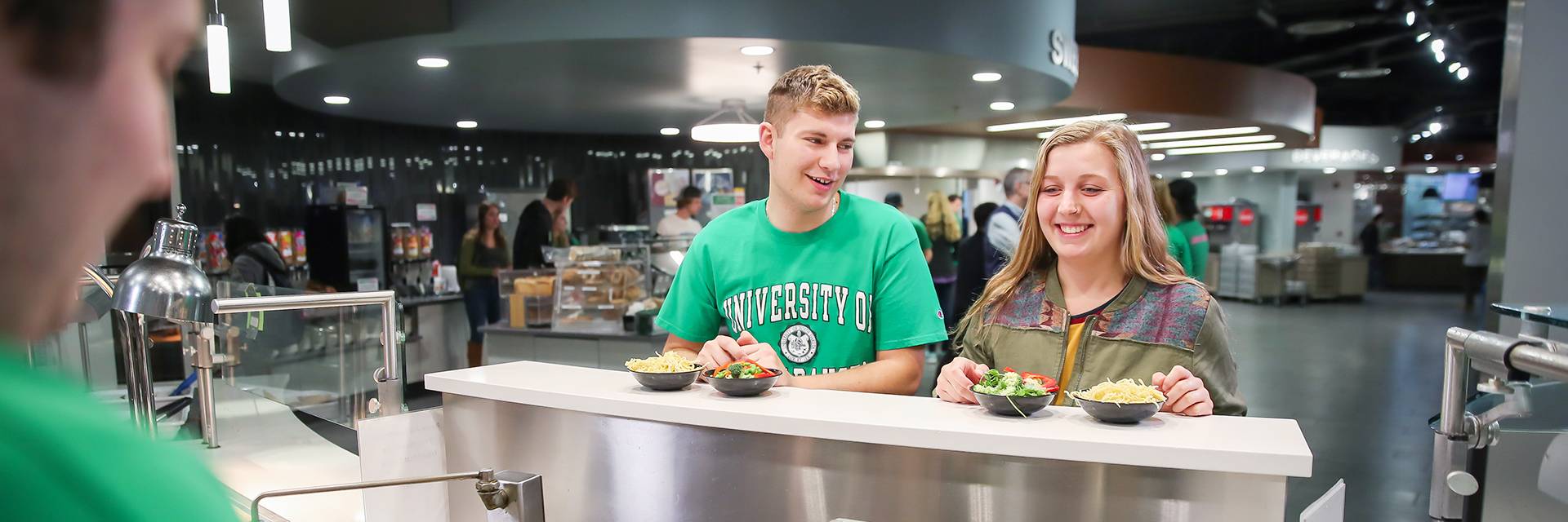 two students waiting for food