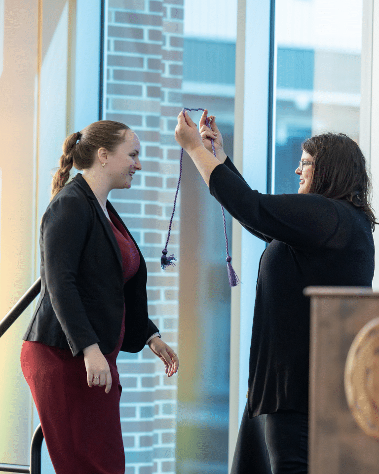 Lavender Graduation graduate receiving lavender cord.