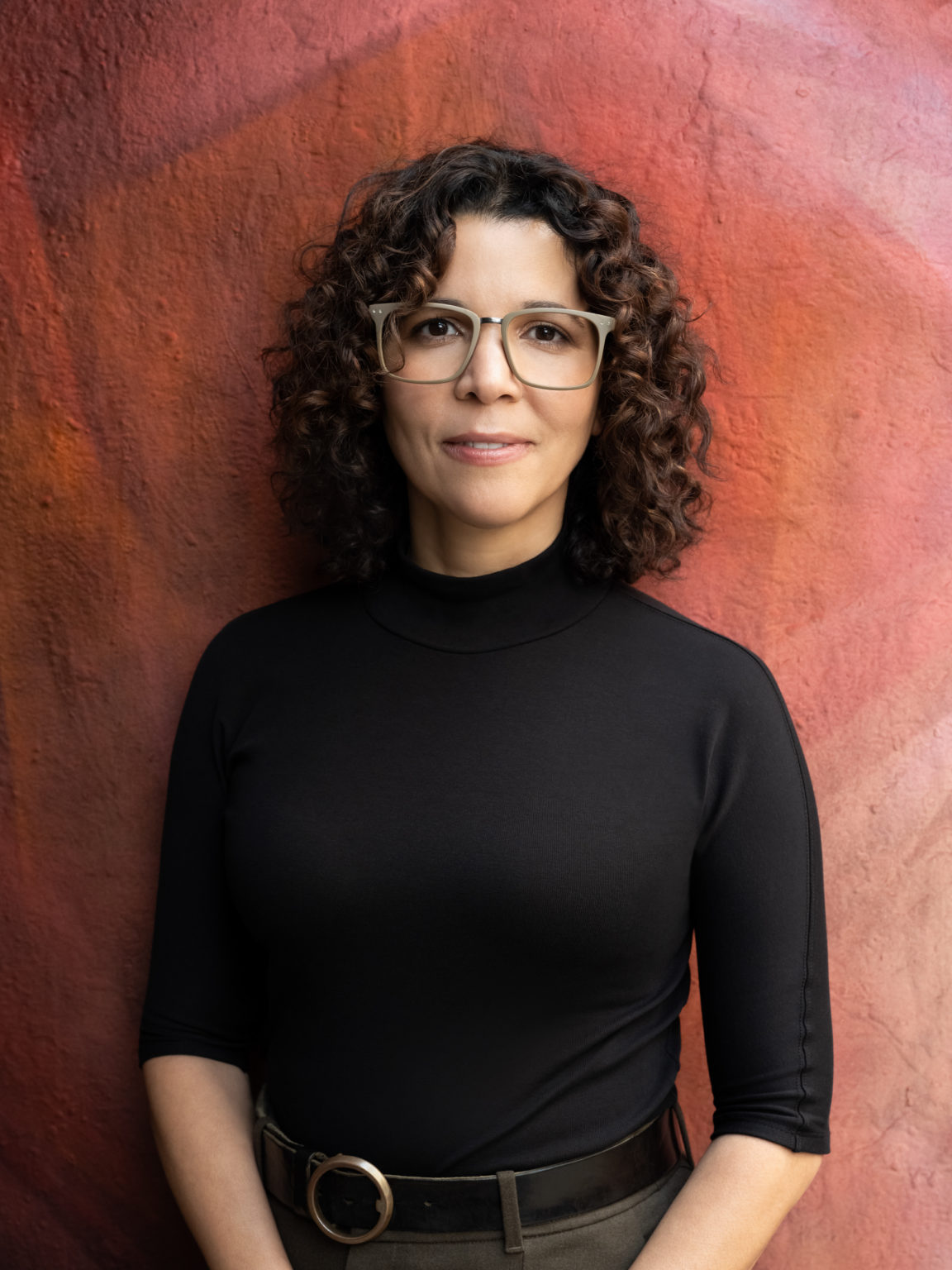 Photograph of author Ananda Lima, wearing a black turtleneck sweater. Photo credit: Beowulf Sheehan